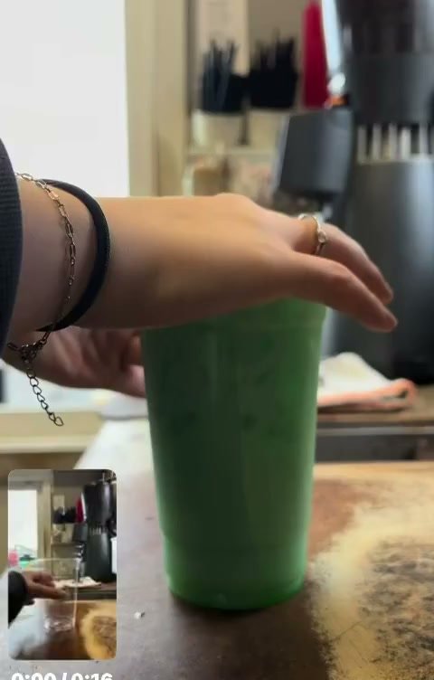 An empty cup at the Lord Hill Espresso counter, about to become a layered green energy drink