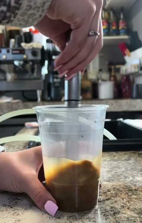 An empty cup on the counter inside Lord Hill Espresso, about to become an iced latte